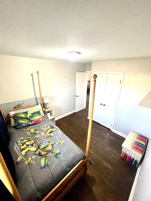 bedroom featuring baseboards and wood finished floors