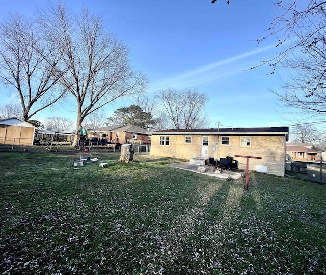 back of house with a yard and fence