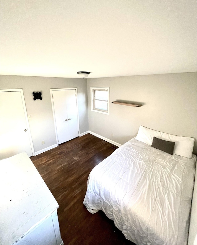 bedroom with baseboards and wood finished floors