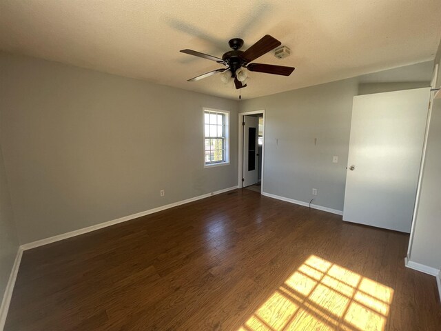 unfurnished room featuring ceiling fan and dark wood-type flooring