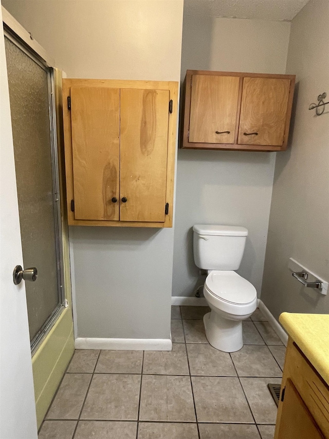 full bathroom with vanity, toilet, enclosed tub / shower combo, and tile patterned floors