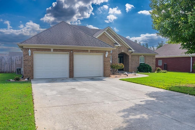 view of front facade with central AC, a front yard, and a garage