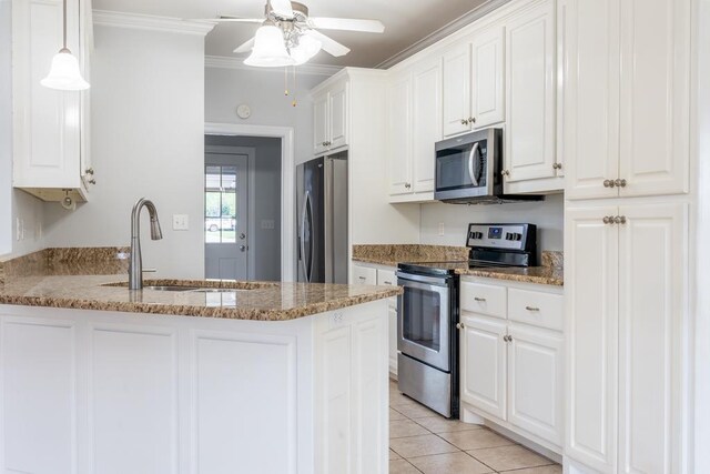 kitchen featuring light stone countertops, appliances with stainless steel finishes, crown molding, sink, and white cabinets