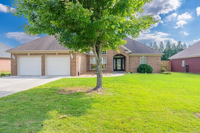 view of front of home with french doors, a front lawn, and a garage