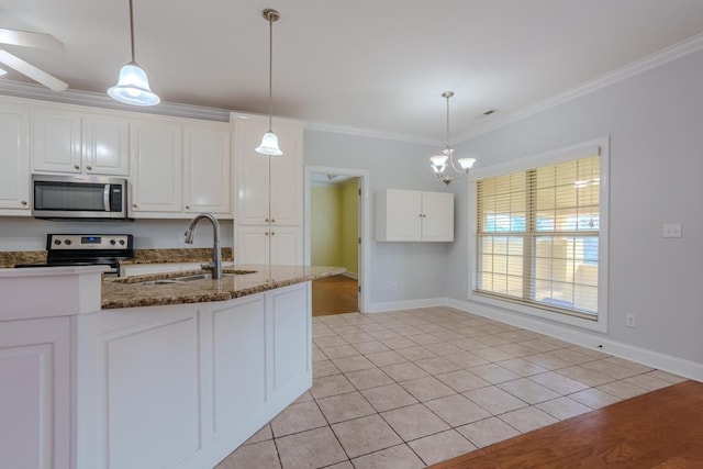 kitchen with white cabinets, appliances with stainless steel finishes, crown molding, and dark stone countertops