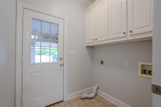 washroom with cabinets, washer hookup, light tile patterned floors, ornamental molding, and hookup for an electric dryer