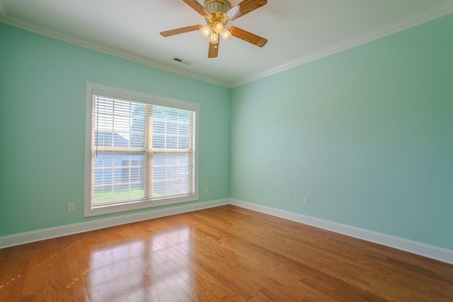 unfurnished room with hardwood / wood-style flooring, ceiling fan, and ornamental molding