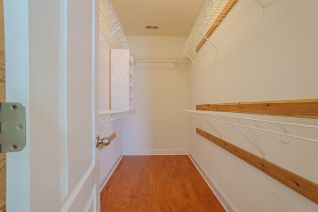 walk in closet with wood-type flooring