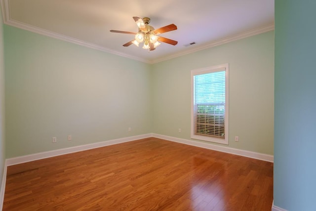 unfurnished room featuring hardwood / wood-style flooring, ceiling fan, and ornamental molding