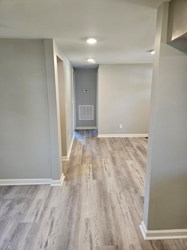 hallway with light hardwood / wood-style flooring