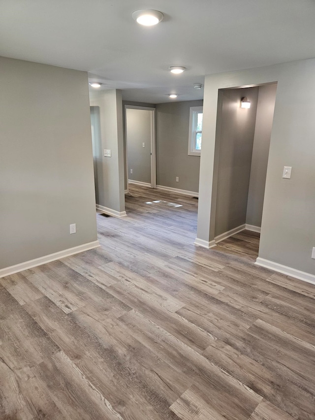 empty room with light hardwood / wood-style flooring