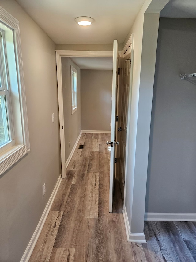 corridor with dark wood-type flooring