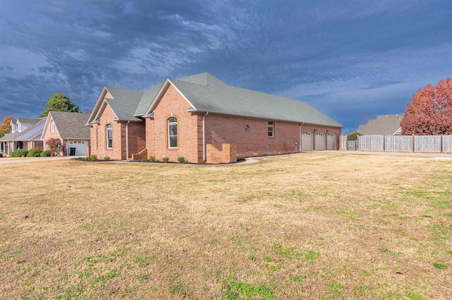 view of side of property with a yard