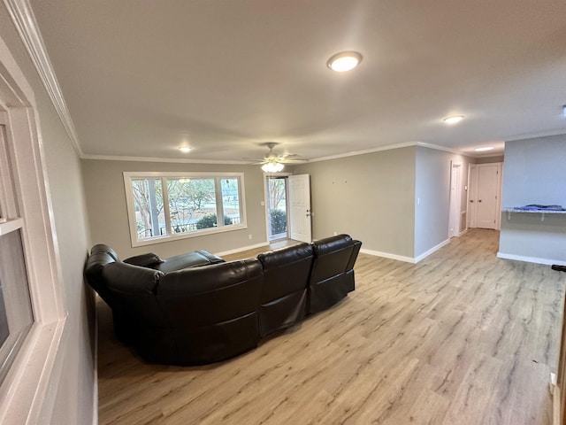 living room with light hardwood / wood-style flooring, ceiling fan, and crown molding