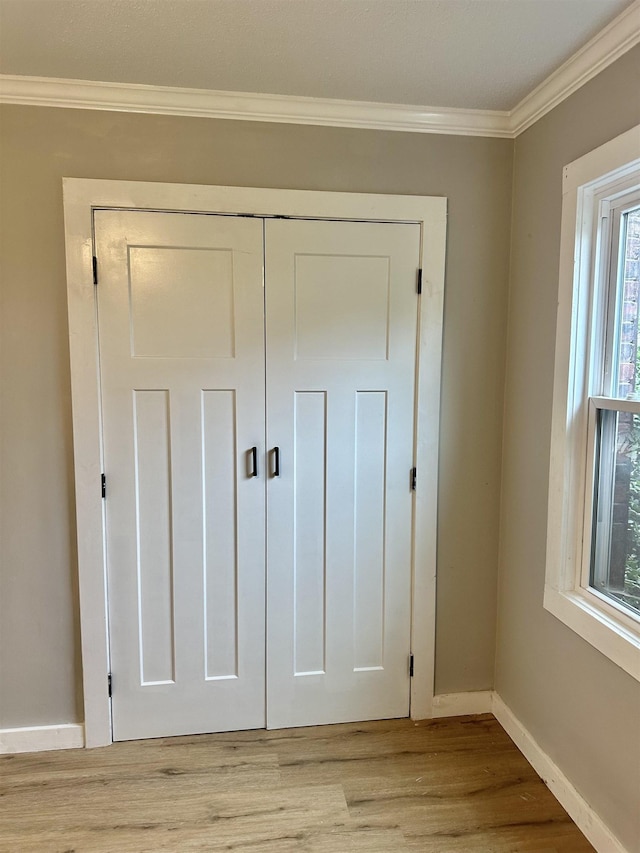 interior details with hardwood / wood-style flooring and ornamental molding