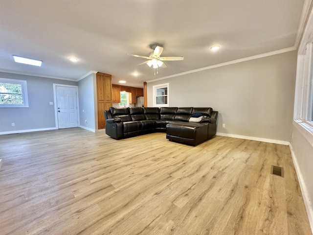 living room featuring ceiling fan, light hardwood / wood-style floors, and ornamental molding