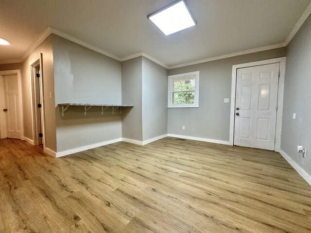 interior space featuring ornamental molding and light hardwood / wood-style flooring