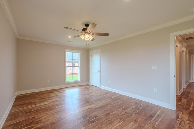 unfurnished room featuring dark hardwood / wood-style flooring, ornamental molding, and ceiling fan