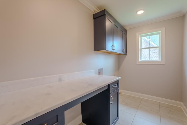 clothes washing area featuring cabinets, ornamental molding, hookup for a washing machine, and light tile patterned floors