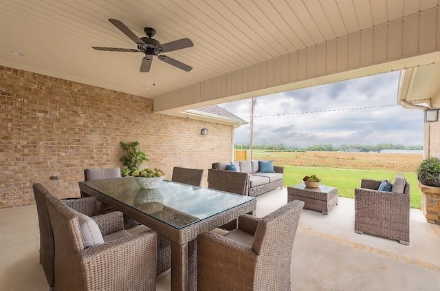 view of patio with a rural view, an outdoor hangout area, and ceiling fan