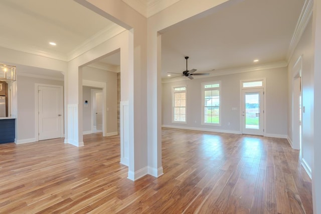 unfurnished living room featuring ornamental molding, ceiling fan, and light hardwood / wood-style floors