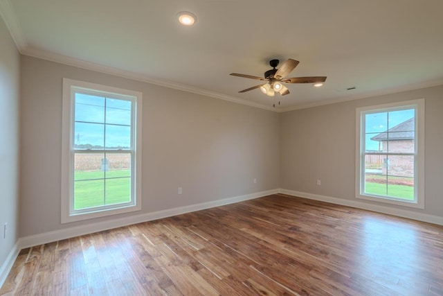 empty room with ornamental molding, light hardwood / wood-style floors, and ceiling fan