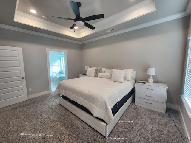 carpeted bedroom with a raised ceiling, ensuite bath, ceiling fan, and crown molding