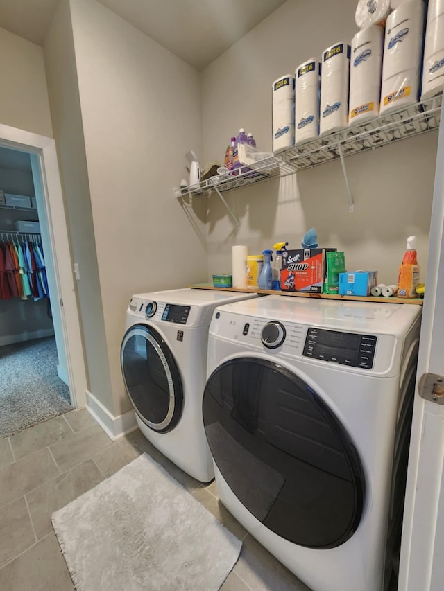 laundry room featuring light carpet and washing machine and clothes dryer