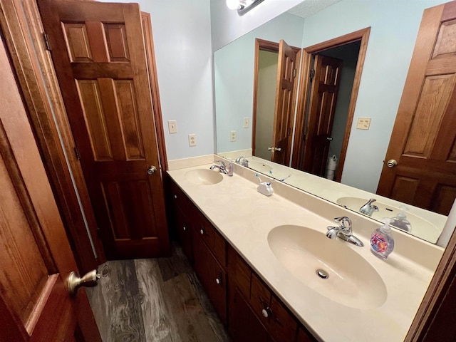 full bath with wood finished floors and double vanity