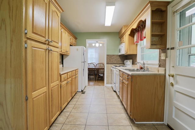 - kitchen featuring white appliances, a sink, light tile patterned floors, and backsplash