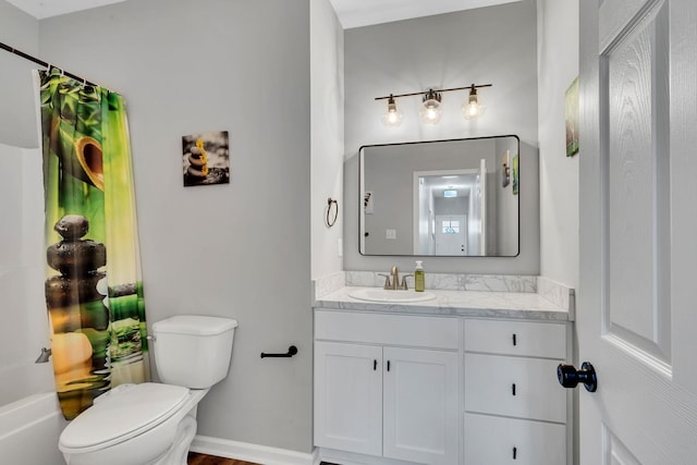 bathroom featuring baseboards, toilet, and vanity