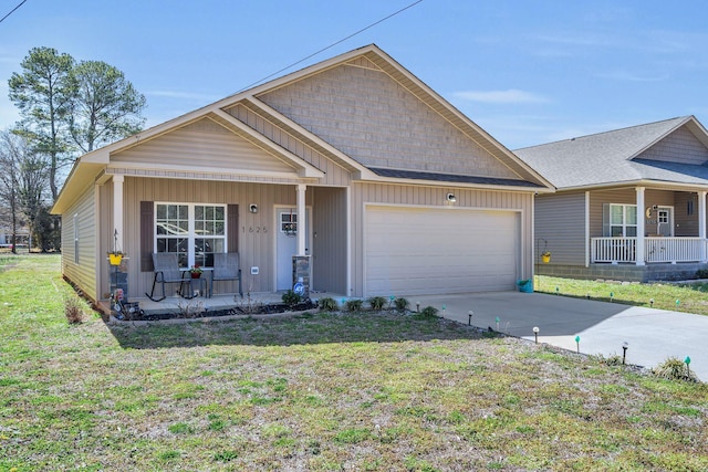 view of front facade featuring a garage, covered porch, and a front yard