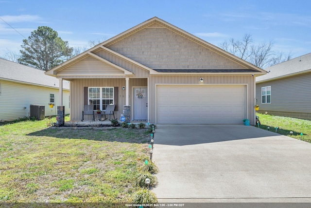 - view of front of home with concrete driveway, an attached garage, board and batten siding, covered porch, and central AC
