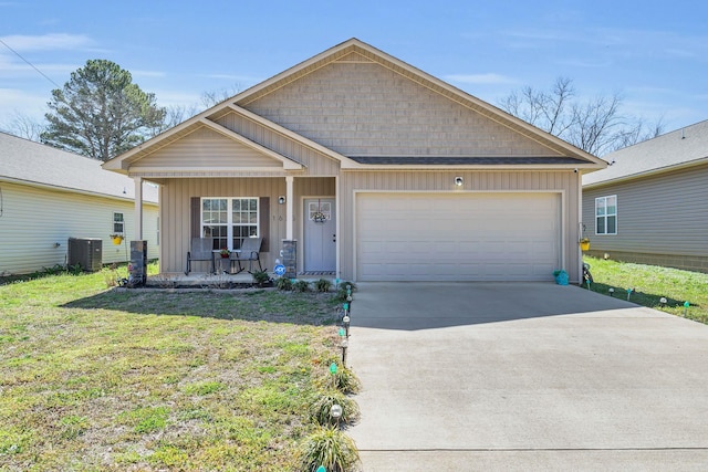 view of front facade featuring central AC, covered porch, board and batten siding, concrete driveway, and a garage