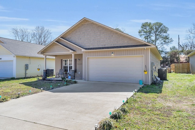 view of front of property with board and batten siding, a front yard, central AC, driveway, and an attached garage