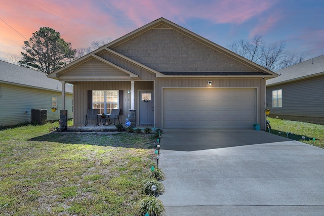 view of front of property with central AC unit, driveway, a porch, an attached garage, and board and batten siding