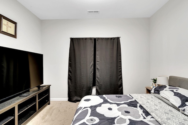 bedroom featuring visible vents, carpet flooring, and baseboards