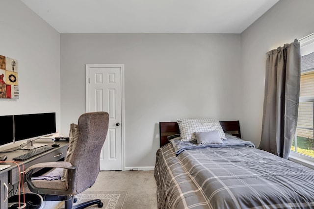 carpeted bedroom featuring baseboards