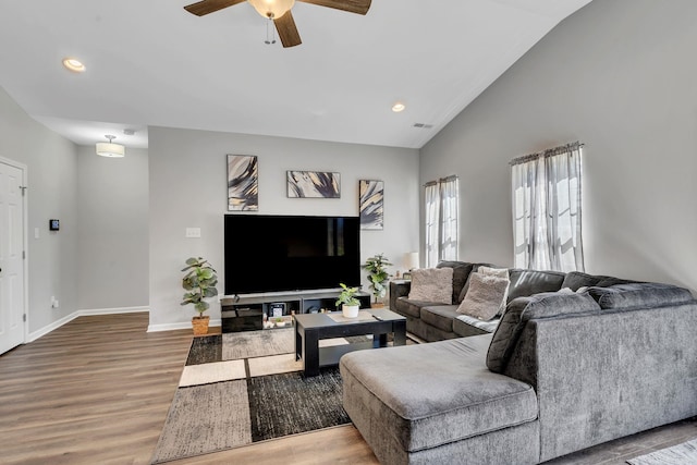 living area with recessed lighting, baseboards, lofted ceiling, and wood finished floors