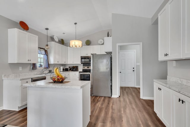 kitchen with light countertops, white cabinets, wood finished floors, and appliances with stainless steel finishes