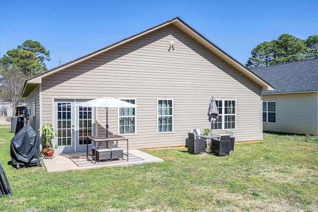 back of property featuring a patio area, a yard, and french doors