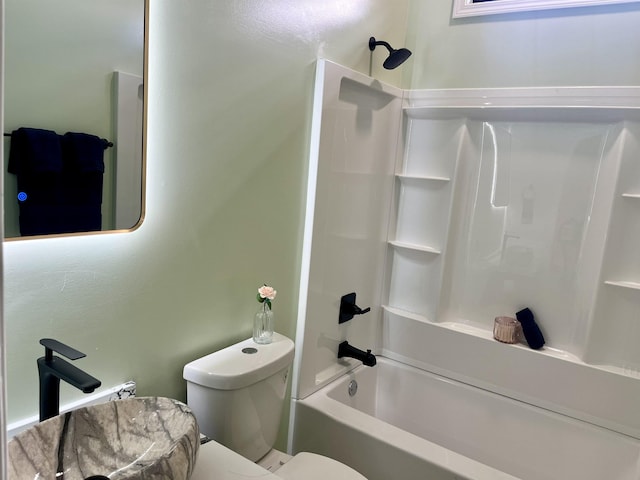 bathroom with bathing tub / shower combination and toilet