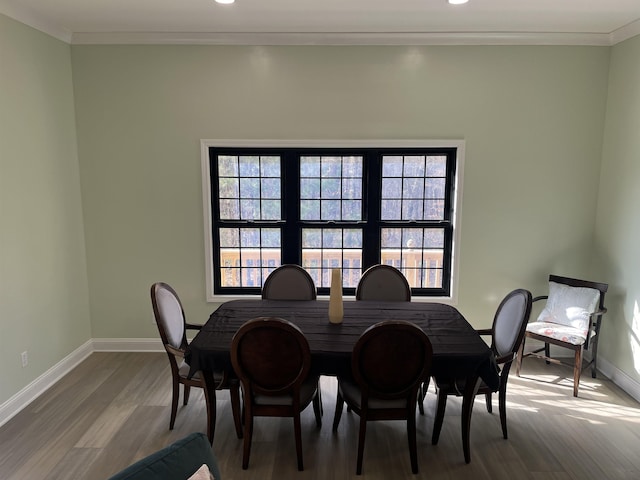 dining area featuring ornamental molding and wood-type flooring