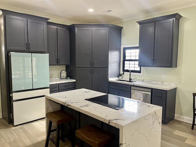 kitchen featuring stainless steel dishwasher, a center island, white fridge, crown molding, and sink