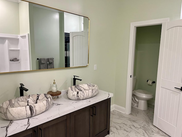 bathroom featuring toilet and vanity