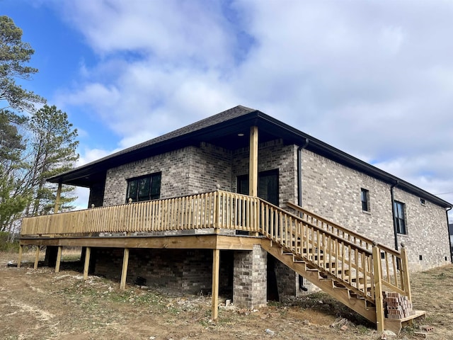 rear view of house with a wooden deck