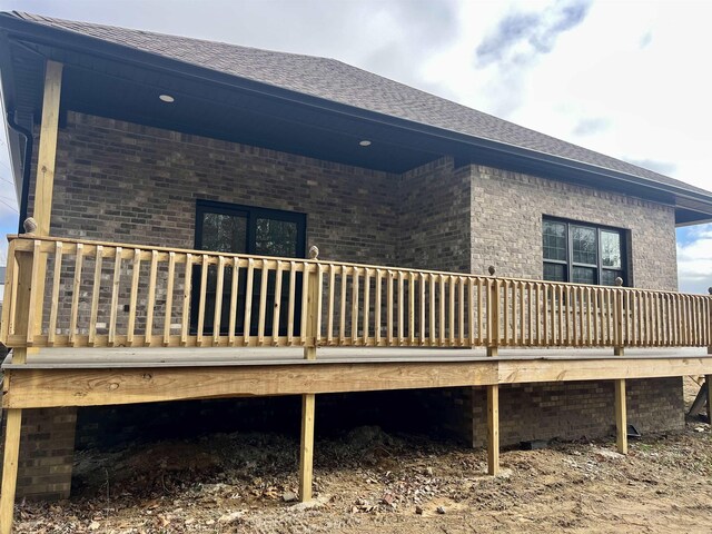 back of house with a wooden deck