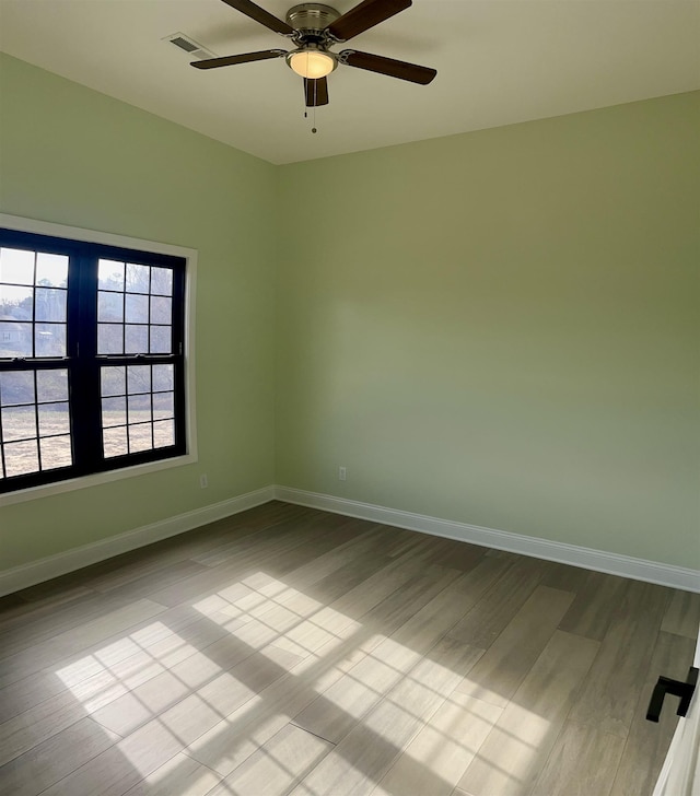 unfurnished room featuring light wood-type flooring and ceiling fan