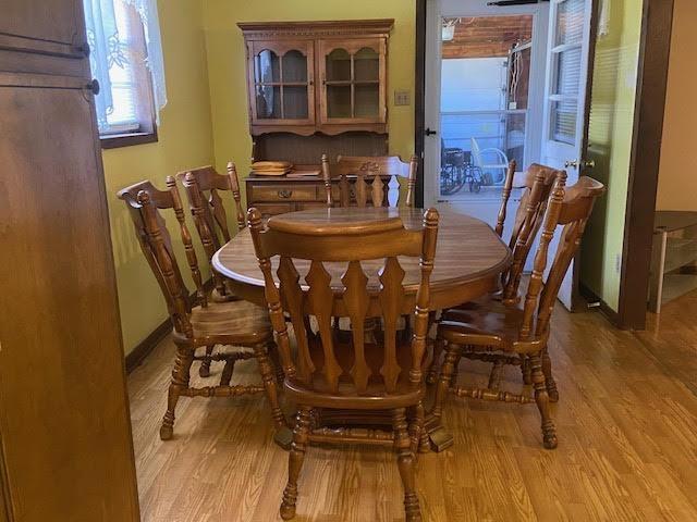 dining area featuring light wood-type flooring and baseboards