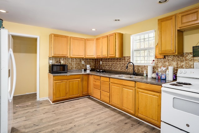  - kitchen featuring white appliances, decorative backsplash, light wood-style floors, and recessed lighting